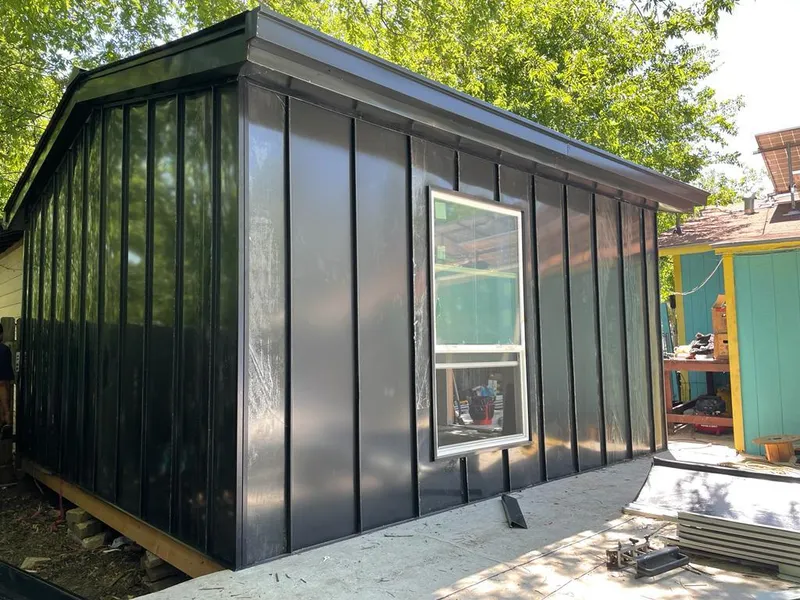 Black standing seam metal wall panels for Roof Inspection in Brier