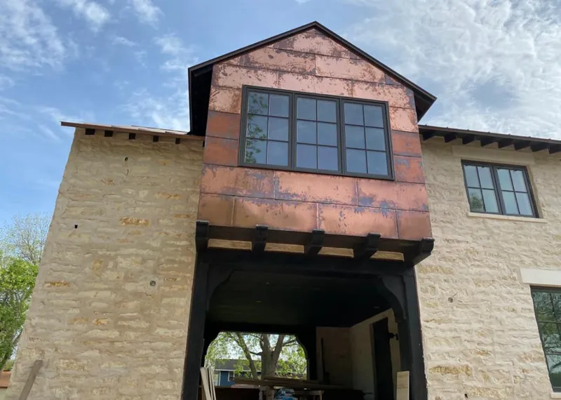 Copper metal panel facade on a stone building for Metal Roof Coating in Brier